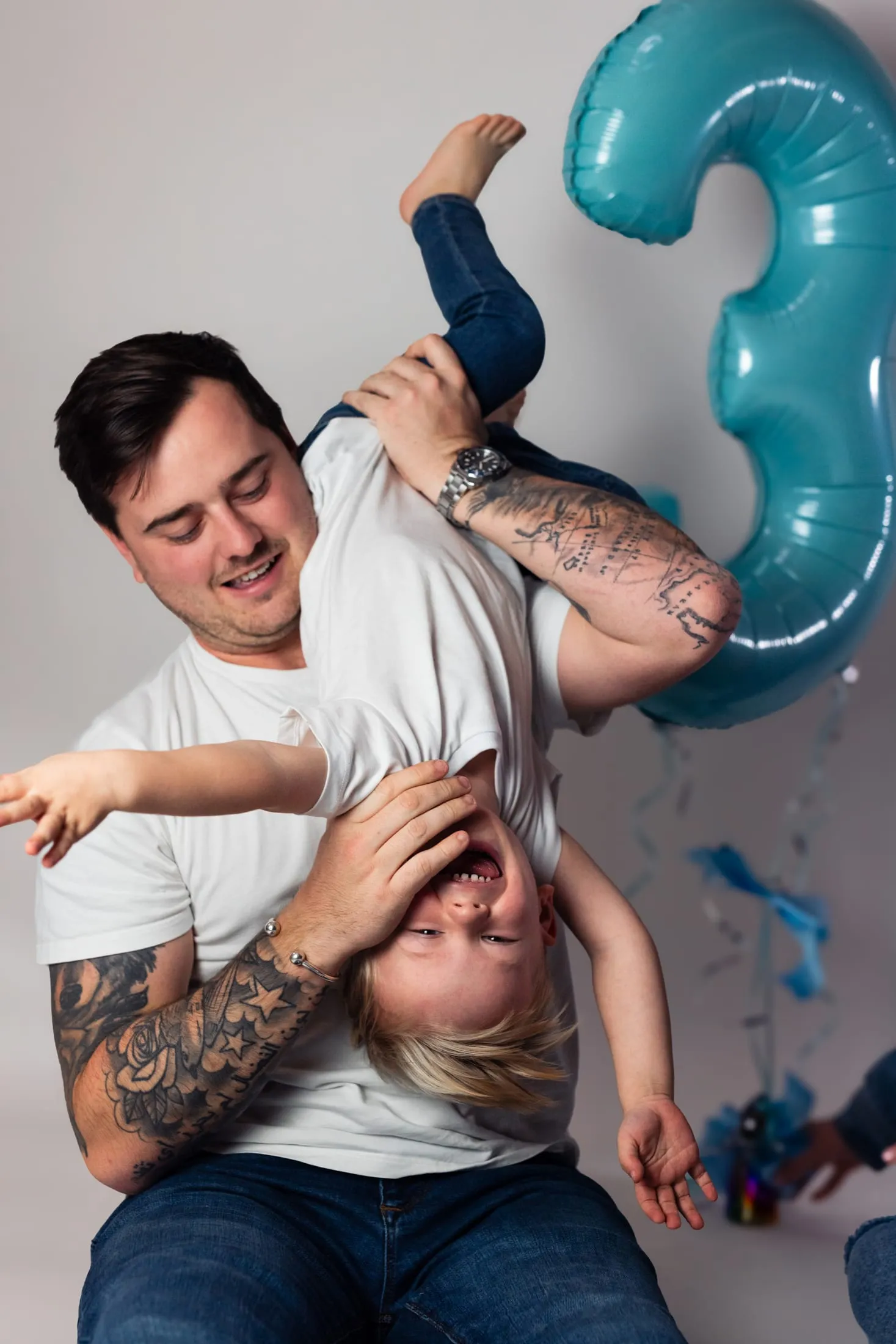 A playful family moment with birthday balloons