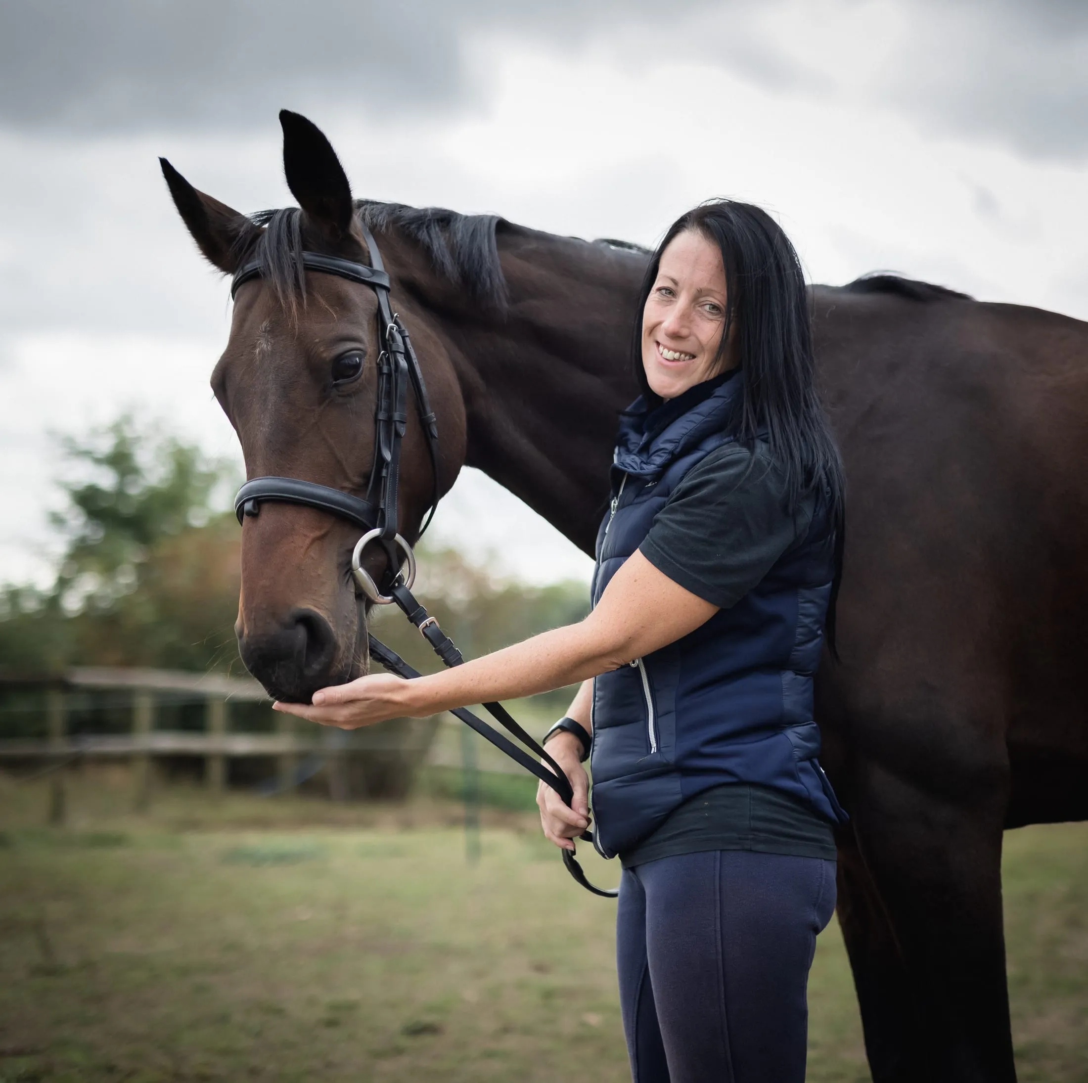 A woman with her horse in soft daylight