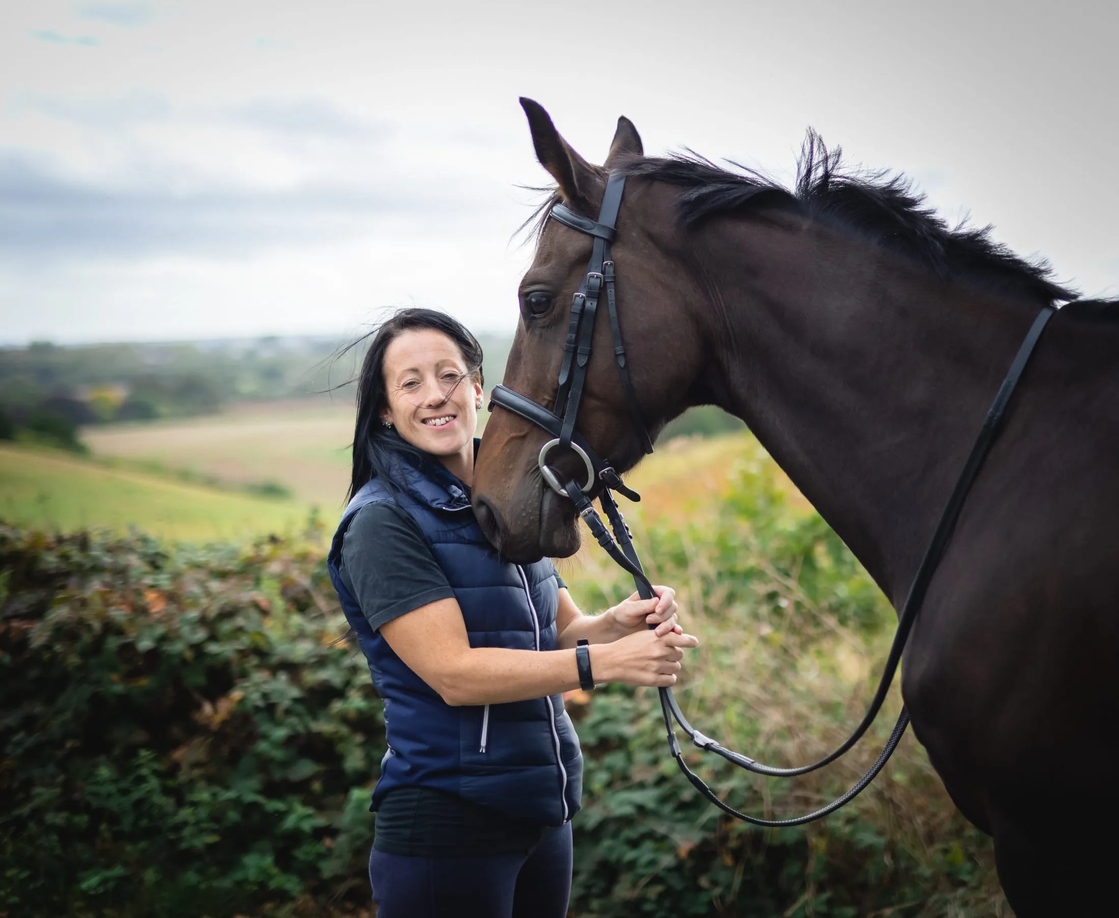 A woman and her horse in open countryside