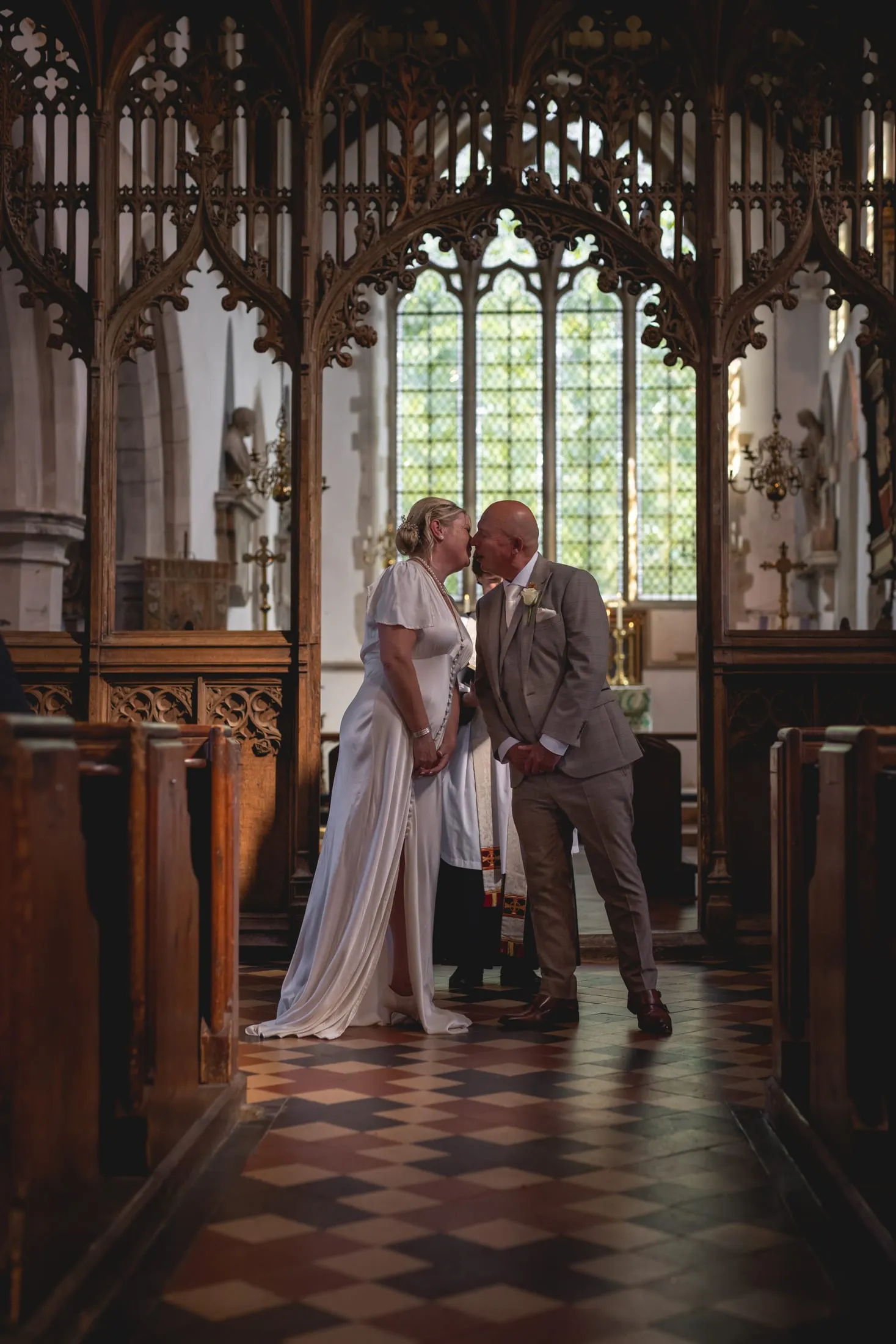 Bride and groom embracing in a sunlit church